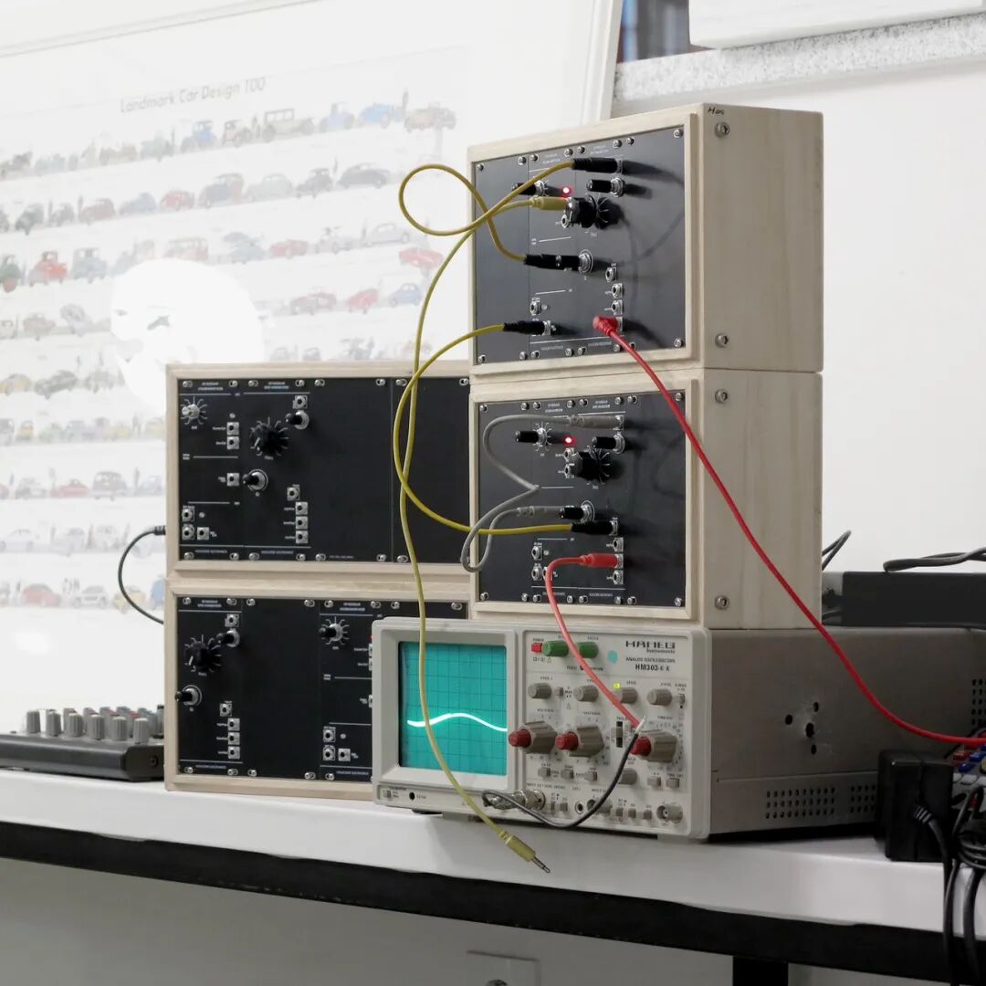 wooden modular synthesizer cases patched into an analog oscilloscope
